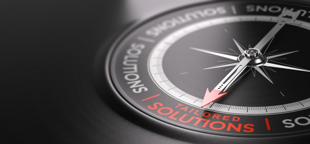 3D illustration of a compass over black background with the text tailored solutions written in red. 